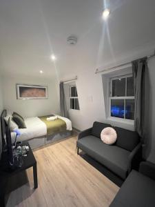 a small room with a bed and a couch at 3 Bedroom Flat in King’s Cross, St Pancras’s. 8 People in London