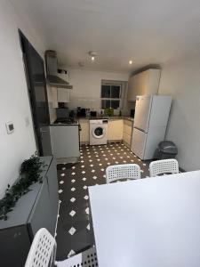 a kitchen with a table and chairs and appliances at 3 Bedroom Flat in King’s Cross, St Pancras’s. 8 People in London