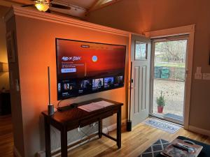 een woonkamer met een flatscreen-tv aan de muur bij Luxury Smart Bungalow in Fayetteville