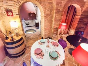 a dining room with a table and a wine barrel at La Scarpetta Magica un soggiorno a 5 stelle spiaggia inclusa in Offida +60 photos