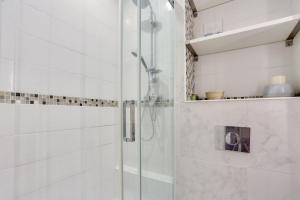 een douche met een glazen deur in de badkamer bij Studio - Appartement Quartier Tour Eiffel 3 in Parijs
