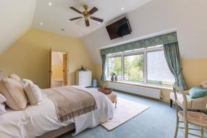 a bedroom with a bed and a window at Stylish 5bed with parking and large garden in Norwich