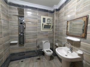 a bathroom with a toilet and a sink at Gem & Pyramids Front in Cairo +29 photos