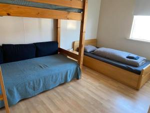 a bedroom with a bunk bed and a couch at House in the Westfjords in Súðavík