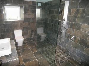 a bathroom with a shower with a toilet and a sink at Criffel Glen in Dumfries
