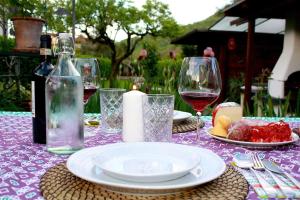 a table with a plate of food and wine glasses at Villa "Corte de' Baldi" in Ortignano Raggiolo +53 photos