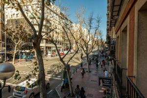a city street with people walking on the sidewalk at Apartment Delicias by SharingCO in Madrid