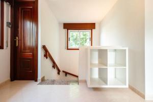 a hallway with a white cabinet next to a door at Casa Bella Lalin- 4 Double bedroom Galician Country Home! in Pontevedra