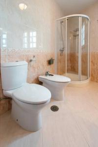a white bathroom with a toilet and a shower at Casa Bella Lalin- 4 Double bedroom Galician Country Home! in Pontevedra