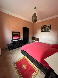 a bedroom with a large red bed and a mirror at Triplex & Pool Tiguert in Agadir