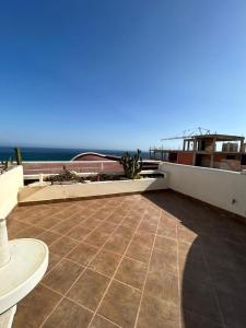 a patio with a view of the ocean on a house at Triplex & Pool Tiguert in Agadir