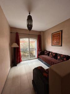 a living room with a couch and a window at Triplex & Pool Tiguert in Agadir