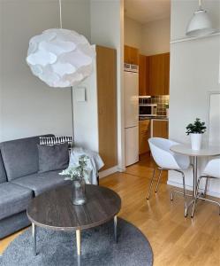 a living room with a couch and a table at Forenom Serviced Apartments Goteborg A-R Lorents Gata in Gothenburg