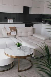 a living room with a white couch and a table at Brighton Apartment by Pier in Brighton & Hove