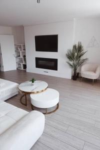 a living room with a couch and tables and a tv at Brighton Apartment by Pier in Brighton & Hove