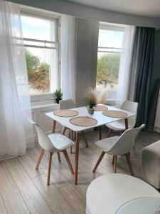 a dining room with a table and chairs and a window at Brighton Apartment by Pier in Brighton & Hove