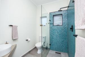 a bathroom with a glass shower and a toilet at Seaview Cottage Barry @ Surf Spray in Southbroom +16 photos