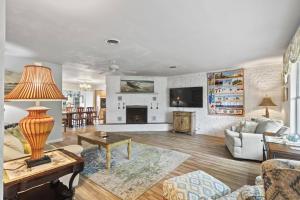 a living room with a couch and a table at Palm Paradise Waterfront Home - Flagler Beach - Dock - Pet Friendly - Close To The Beach in Flagler Beach
