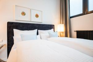 Postel nebo postele na pokoji v ubytování Apartments Leopold Ferdinand