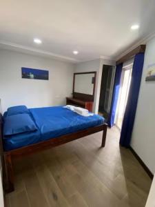 a bedroom with a blue bed in a room at Sliema - Double Room in Sliema