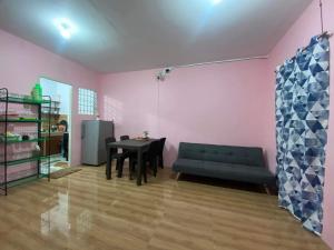 a living room with a black couch and a table at M&L Property in Dumaguete