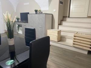 an office with stairs and a desk and chairs at B&B C'era una volta in Solferino