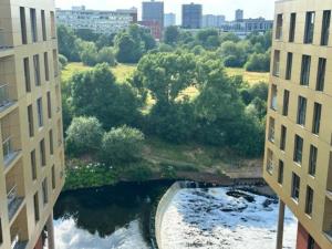 an aerial view of a river between two buildings at XL 2 Bed Central MCR Apt Sleeps 7 in Manchester