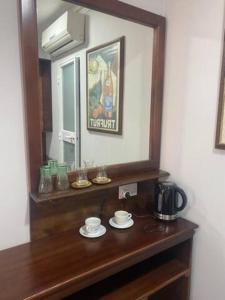 a wooden table with a mirror and a coffee maker on it at Sliema - Double Room in Sliema