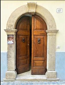 eine Holztür in einem Torbogen in einem Gebäude in der Unterkunft Casa Vittorio Emanuele in Fiuggi
