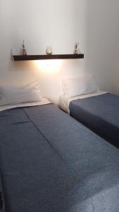 two beds sitting next to each other in a room at LO DE CHUCHO in Don Torcuato