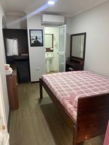 a bedroom with a bed and a bathroom at Sliema - Double Room in Sliema