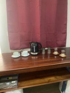 a table with a tea kettle and plates on it at Sliema - Double Room in Sliema