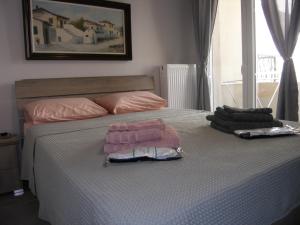 a bedroom with a bed with two towels on it at Pela's Apartment for Filoxenia in Alexandroupoli