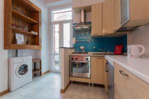 a kitchen with a stove and a washing machine at Secondin Apartment by Wonderful Italy in Turin