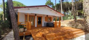 a small house with a deck in the woods at Casa do Bosque in Sintra