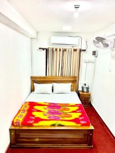 a bedroom with a colorful bed in a room at KINGS HOTEL in Colombo