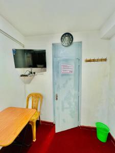 a room with a table and a clock on the wall at KINGS HOTEL in Colombo