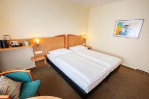 Postel nebo postele na pokoji v ubytování ACHAT Hotel Braunschweig + 37 fotografií