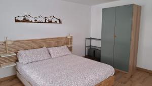 a small bedroom with a bed and a cabinet at Staguda 59 in Sottoguda