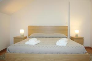 a bedroom with a large bed with towels on it at Lugar dos Louros 1 in Estreito da Calheta