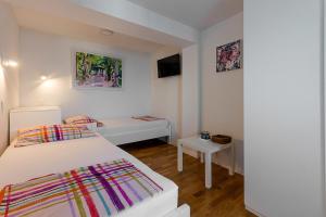 a small room with two beds and a tv at Holiday Home Marija in Dramalj