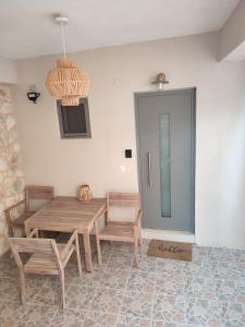 a dining room with a wooden table and chairs at Le Magne Apartments Kardamili in Kardamili