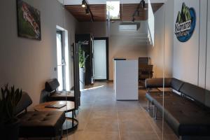 a waiting room with couches and a table and a counter at Готель Карпатія in Mukacheve
