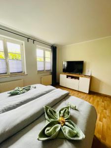 a bedroom with two beds and a flat screen tv at Ferienwohnungen Anne in Schönebeck