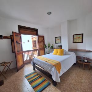 a bedroom with a large bed and a window at Balcones del Ayer in Salento +5 photos