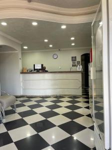 a waiting room with a cash register and a checkered floor at GUTIERREZ HOTEL in Americana