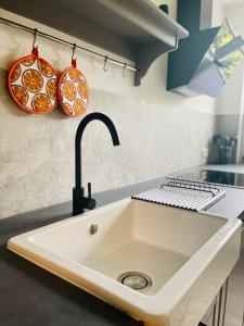 a kitchen with a sink and two plates on the wall at Ferienwohnungen Anne in Schönebeck +33 photos