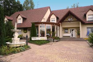 a house with a large glass door and a brick driveway at Hôtel sud alsace in Ranspach-le-Bas