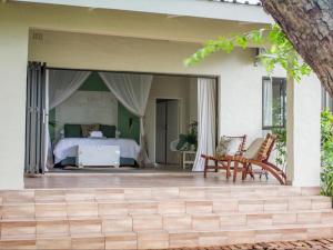 a master bedroom with a bed and a patio at 701 Victoria Falls in Victoria Falls