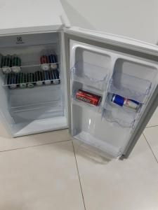 a small refrigerator with its door open in a kitchen at Brookfield Tower in Goiânia